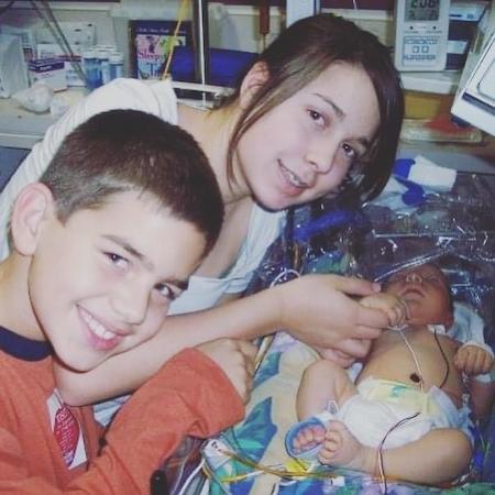 Jaxon with older sister and brother in hospital bed