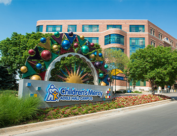 Photo of Children's Mercy Kansas City with a sign that reads, "Children's Mercy Adele Hall Campus."
