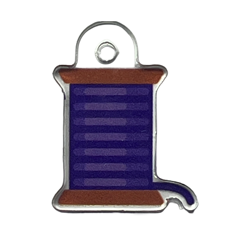 Acrylic charm with a purple sewing thread spool icon.